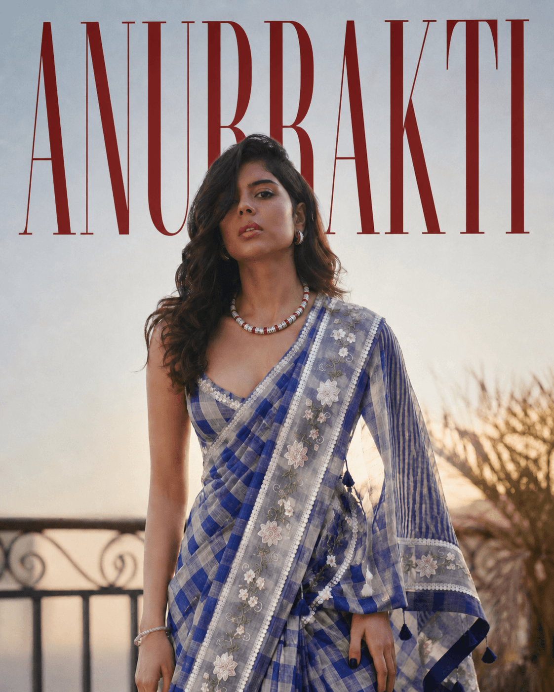 Woman wearing a blue checked ANURRAKTI saree with floral embroidery