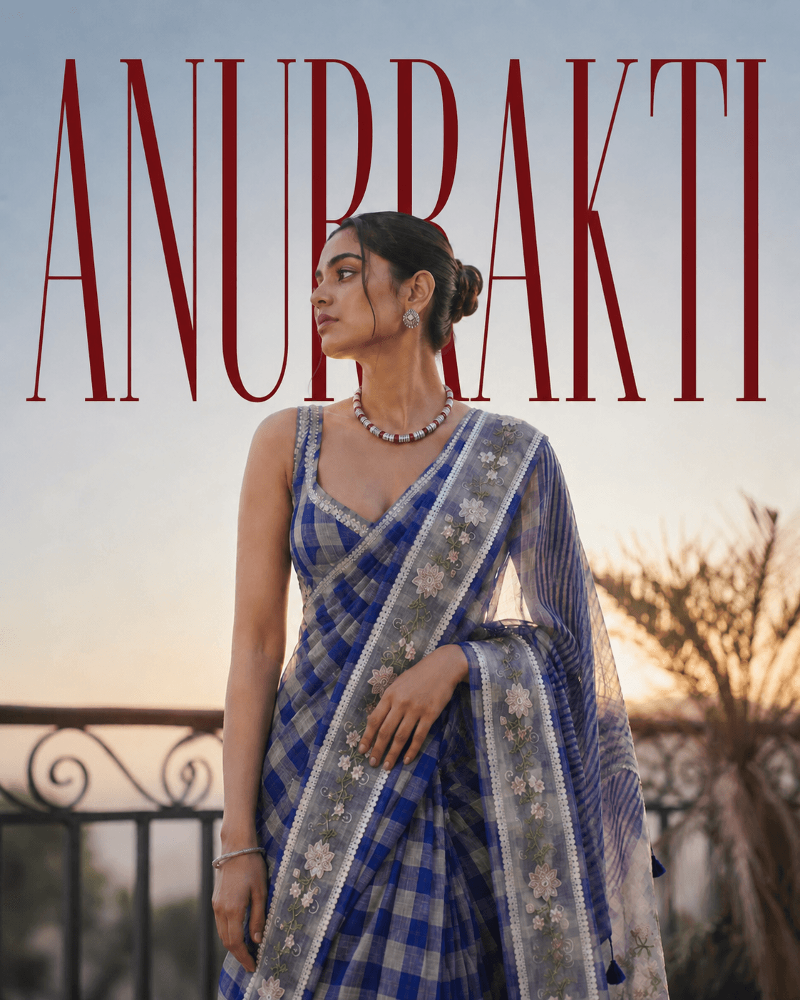 Woman wearing a blue checked ANURRAKTI saree with embroidered borders and a translucent pallu
