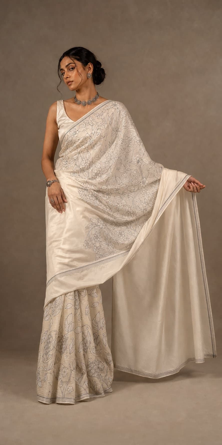 Model wearing NOOR 01 in ivory with silver-toned floral linework